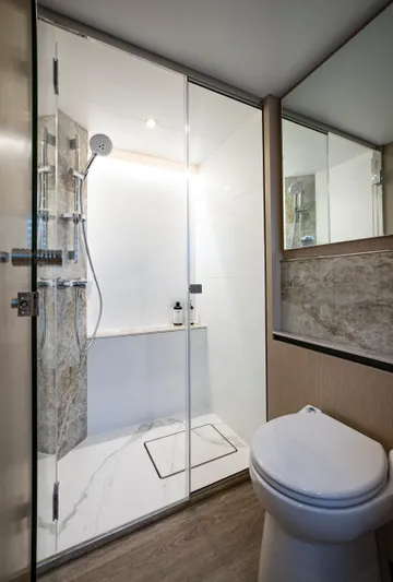 Aquila 70 Yacht Photos Pics Modern bathroom in 2026 Aquila 70 Luxury yacht with glass shower and sleek design.