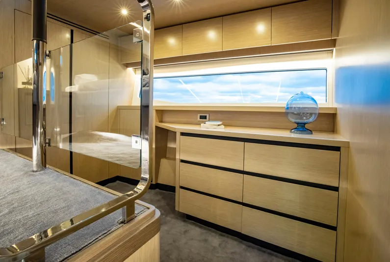 Aquila 70 Yacht Photos Pics Luxurious interior of 2026 Aquila 70 yacht with modern wood cabinetry and large window.