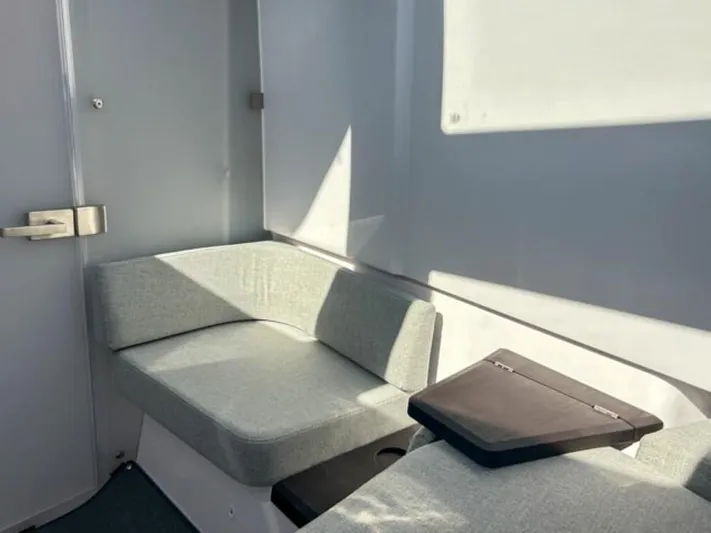  Yacht Photos Pics 2024 Axopar 37XC CROSS CABIN interior with gray seating and modern design.