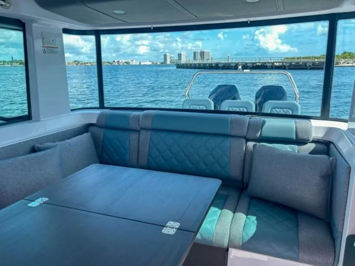  Yacht Photos Pics Interior of 2024 Axopar 37XC CROSS CABIN with waterfront view and comfortable seating.