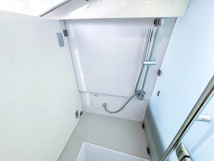  Yacht Photos Pics 2024 Axopar 37XC CROSS CABIN shower area with modern fixtures and sleek design.