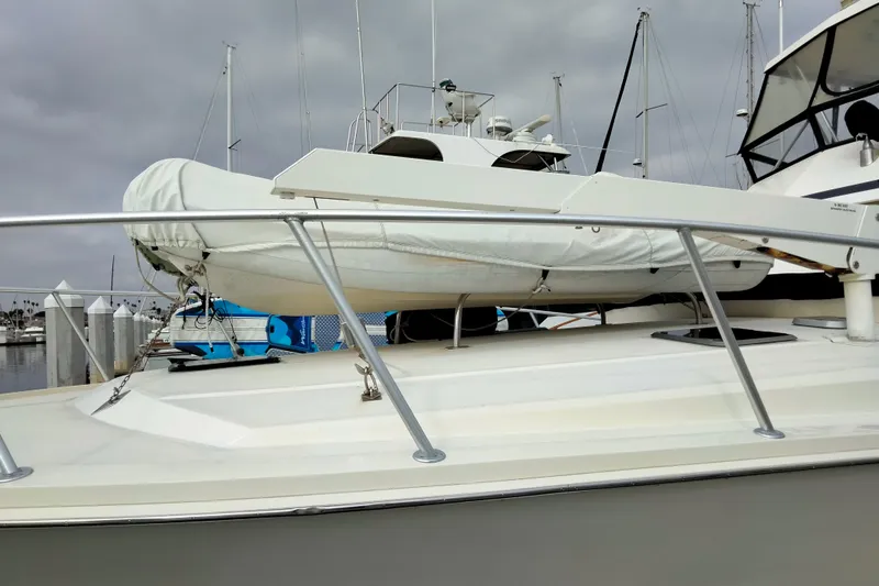Always Right Yacht Photos Pics 1988 Viking 48 Convertible yacht with covered dinghy on deck, docked at marina.