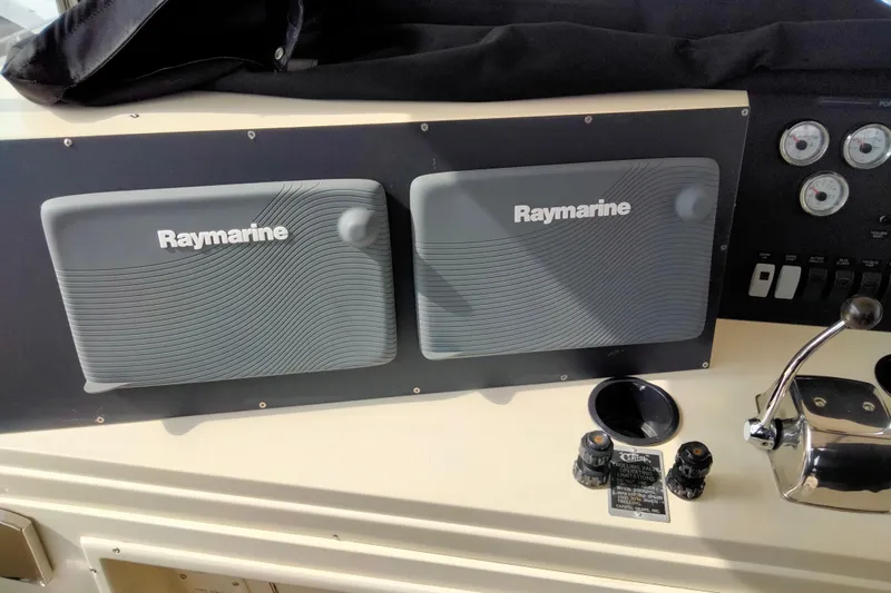 Always Right Yacht Photos Pics Control panel of 1988 Viking 48 Convertible with Raymarine equipment and gauges.