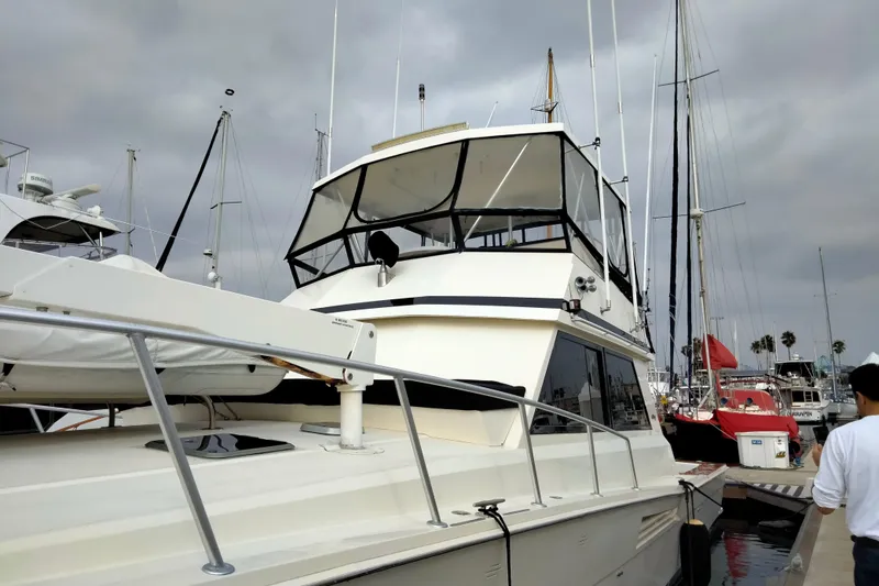 Always Right Yacht Photos Pics 1988 Viking 48 Convertible yacht docked at marina under cloudy skies.