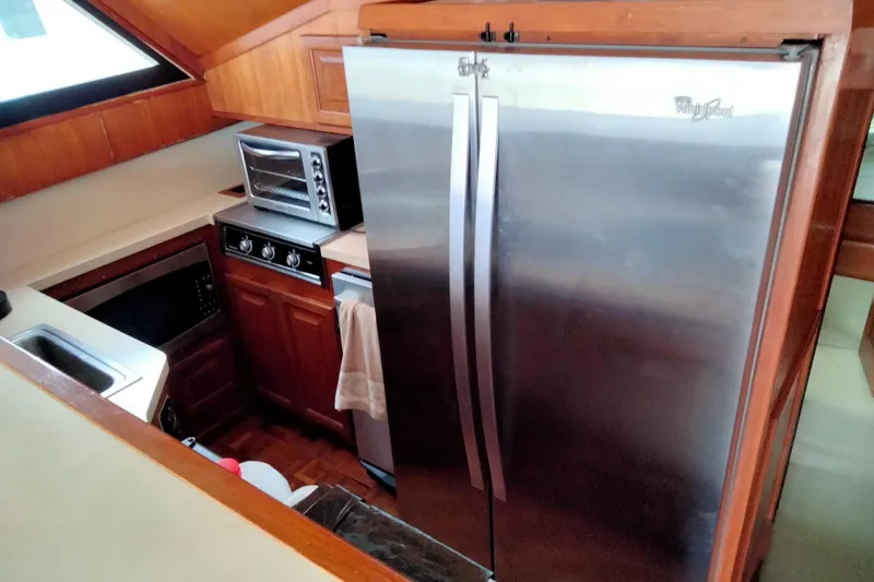 Always Right Yacht Photos Pics Galley kitchen in 1988 Viking 48 Convertible yacht with stainless steel appliances.