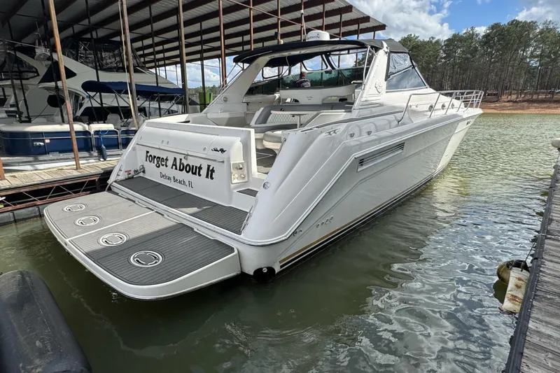  Yacht Photos Pics 1996 Sea Ray 500 Sedan Bridge yacht docked, rear view, named "Forget About It."
