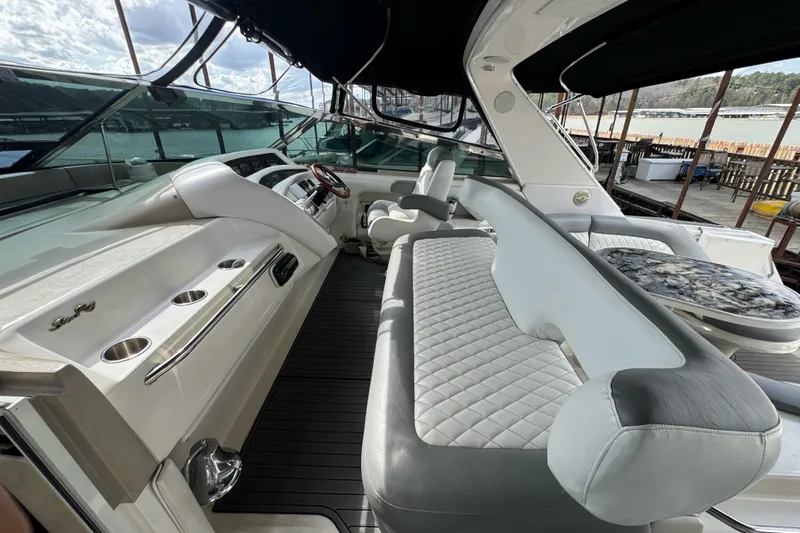  Yacht Photos Pics Luxurious interior of 1996 Sea Ray 500 Sedan Bridge yacht with plush seating and helm.
