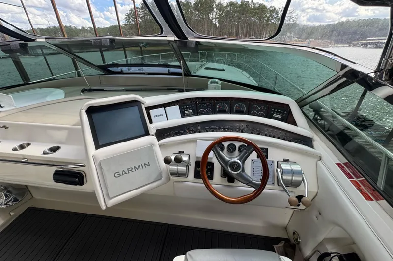  Yacht Photos Pics 1996 Sea Ray 500 Sedan Bridge helm with Garmin navigation system and wood-accented steering wheel.