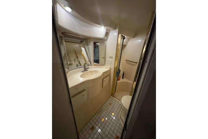  Yacht Photos Pics Bathroom interior of 1996 Sea Ray 500 Sedan Bridge yacht, featuring sink and shower.