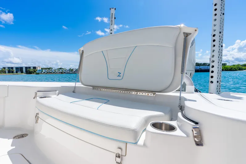  Yacht Photos Pics 2022 SeaVee 270Z boat interior with white seating and cup holder, under a clear blue sky.