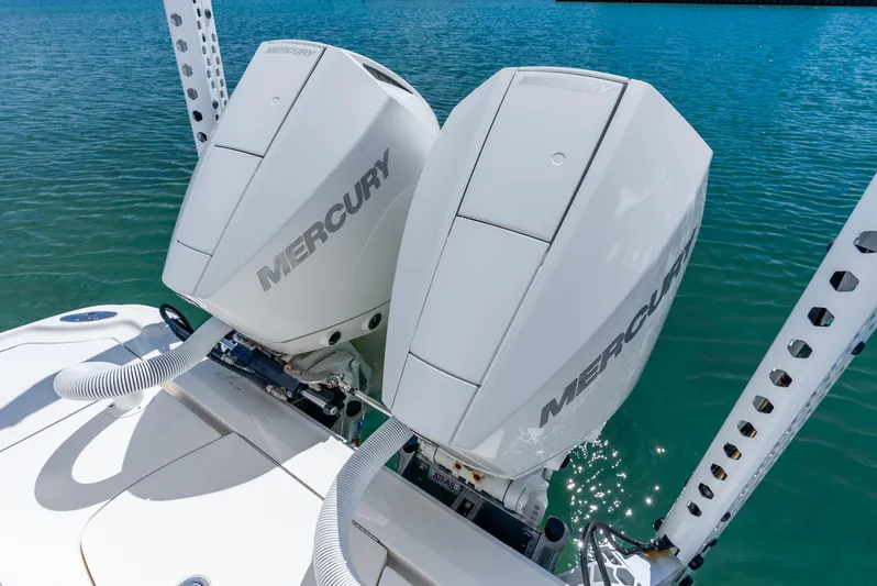  Yacht Photos Pics Twin Mercury outboard engines on a 2022 SeaVee 270Z boat, docked on clear blue water.