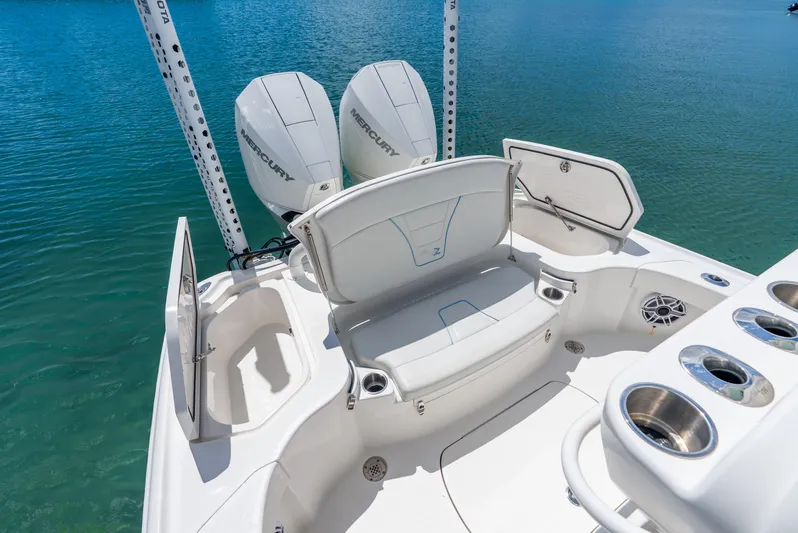  Yacht Photos Pics 2022 SeaVee 270Z boat with dual Mercury engines, spacious seating, and cup holders on calm water.