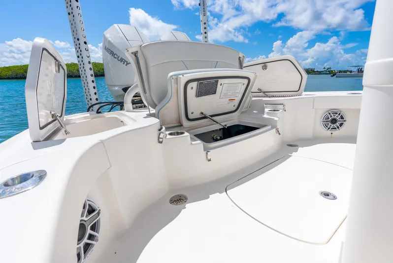  Yacht Photos Pics 2022 SeaVee 270Z boat deck with open storage compartments and Mercury engine.