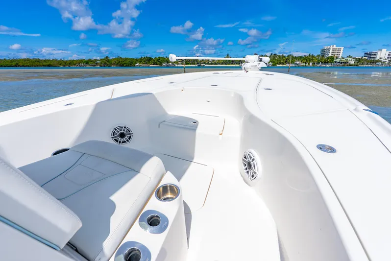  Yacht Photos Pics 2022 SeaVee 270Z boat interior with seating, cup holders, and speakers on a sunny day.
