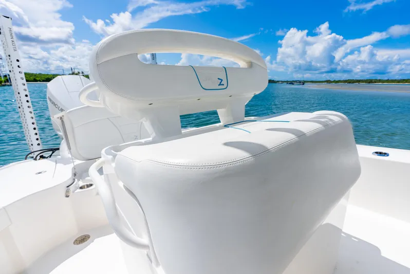  Yacht Photos Pics 2022 SeaVee 270Z boat with white seating, on a sunny day by the water.