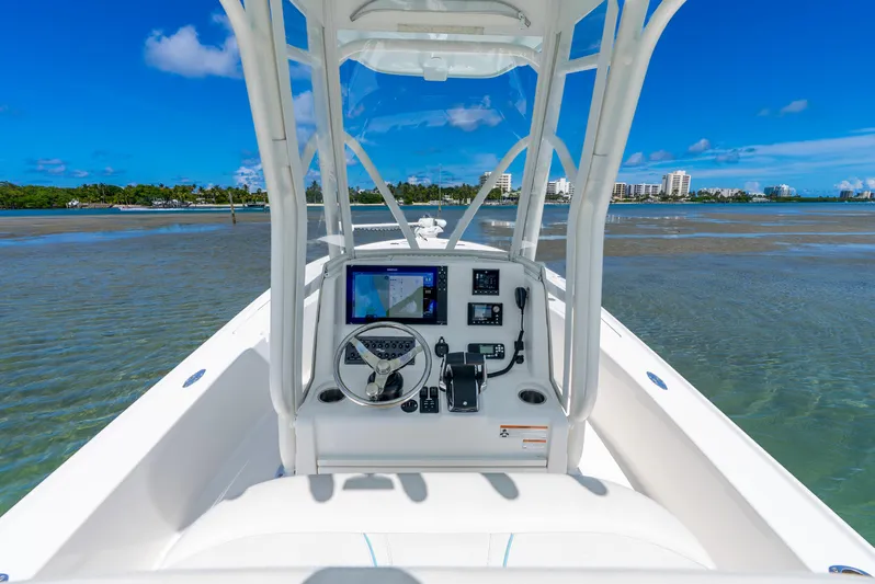  Yacht Photos Pics 2022 SeaVee 270Z boat console with navigation system on calm waters.