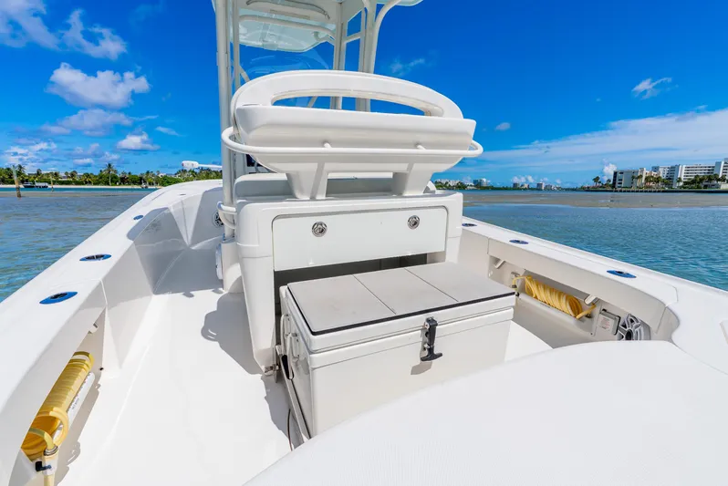  Yacht Photos Pics 2022 SeaVee 270Z boat interior with seating and storage, set against a clear blue sky.