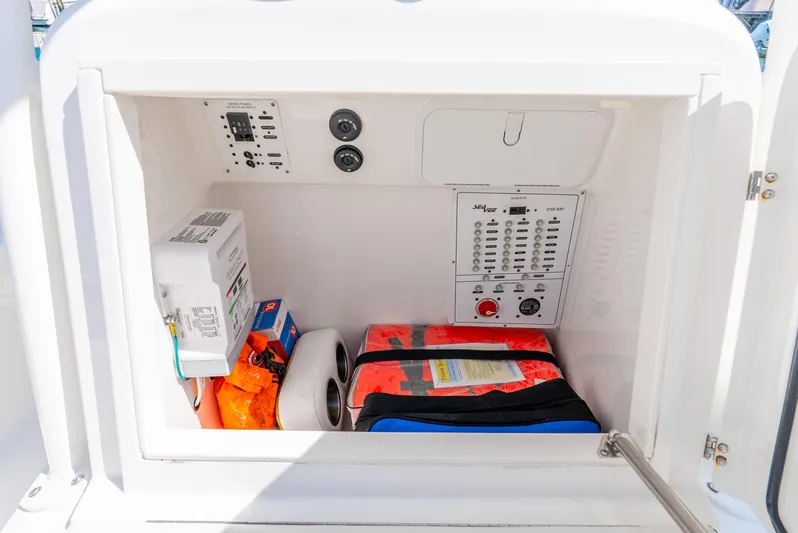  Yacht Photos Pics Storage compartment in 2022 SeaVee 270Z boat with safety equipment and control panel.