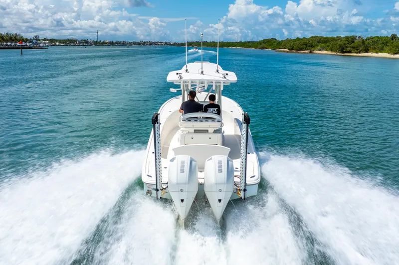  Yacht Photos Pics 2022 SeaVee 270Z boat cruising on clear blue water under a sunny sky.
