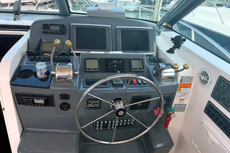 Mavi Yacht Photos Pics Helm of 2004 Tiara Yachts 4200 Open with steering wheel and navigation controls.