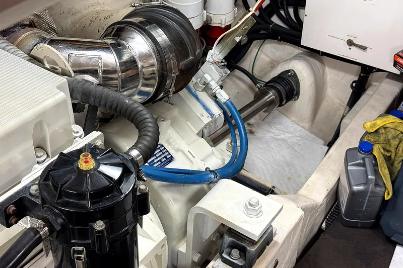 Mavi Yacht Photos Pics Engine compartment of a 2004 Tiara Yachts 4200 Open, showcasing mechanical components and fluid containers.