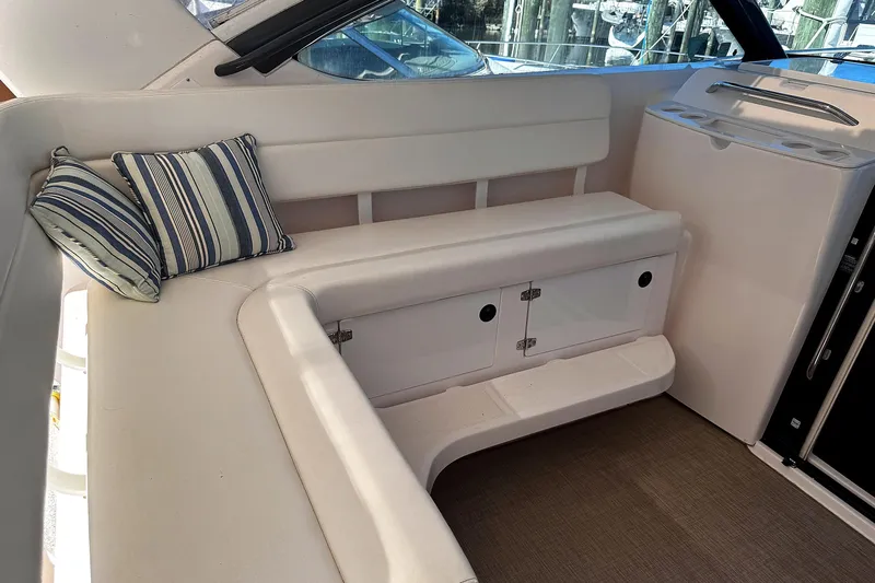 Mavi Yacht Photos Pics 2004 Tiara Yachts 4200 Open interior seating with striped cushions and storage.
