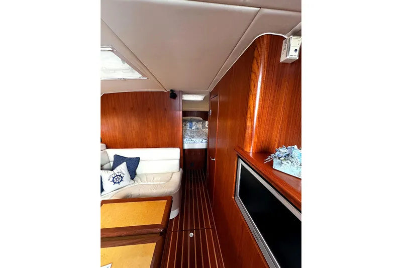 Mavi Yacht Photos Pics Interior of 2004 Tiara Yachts 4200 Open, featuring wood paneling and comfortable seating.