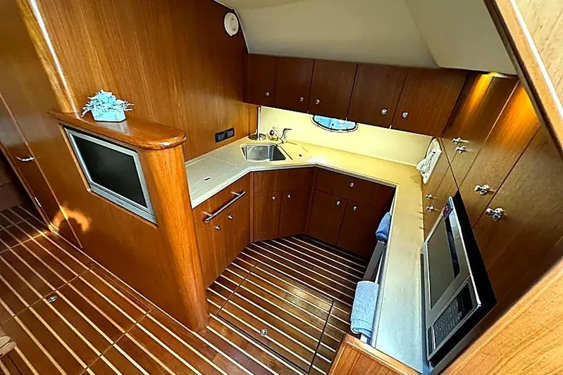 Mavi Yacht Photos Pics Luxurious 2004 Tiara Yachts 4200 Open kitchen with wood cabinetry and modern appliances.