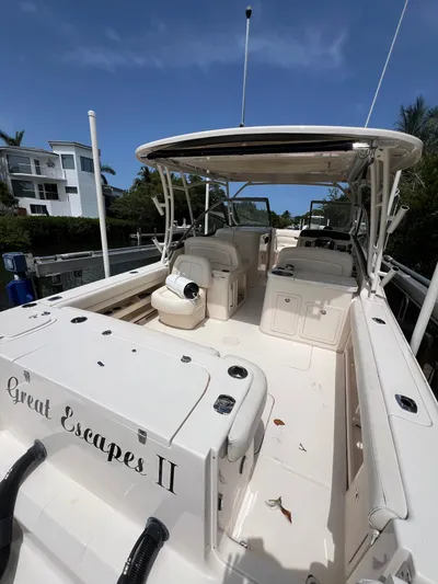  Yacht Photos Pics 2015 Grady-White Freedom 307 boat docked, spacious deck, clear sky background.