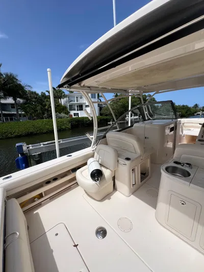  Yacht Photos Pics 2015 Grady-White Freedom 307 boat interior with seating and console, docked by water.