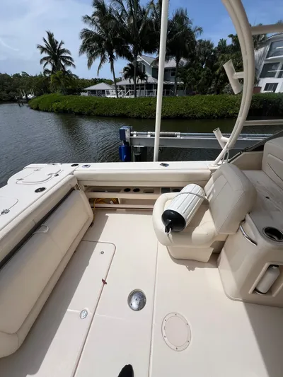  Yacht Photos Pics 2015 Grady-White Freedom 307 boat interior with seating, near waterfront and palm trees.