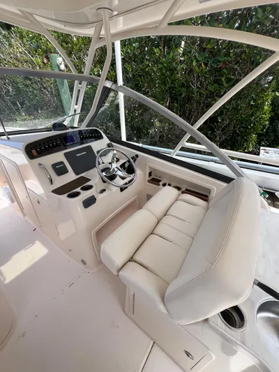  Yacht Photos Pics 2015 Grady-White Freedom 307 boat cockpit with steering wheel and seating.