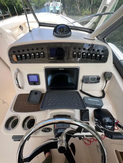  Yacht Photos Pics 2015 Grady-White Freedom 307 boat dashboard with navigation controls and steering wheel.