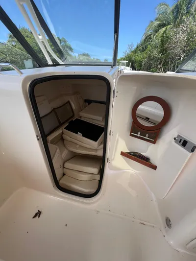  Yacht Photos Pics 2015 Grady-White Freedom 307 boat cabin interior with seating and mirror.