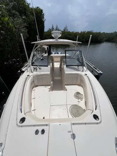  Yacht Photos Pics 2015 Grady-White Freedom 307 boat docked on a calm river.