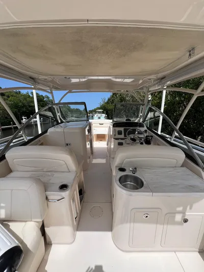  Yacht Photos Pics 2015 Grady-White Freedom 307 boat interior with seating, steering wheel, and sink.