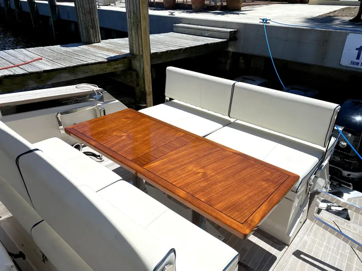  Yacht Photos Pics Azimut Atlantis Verve Outboard 2014 boat with elegant wooden table and white seating.