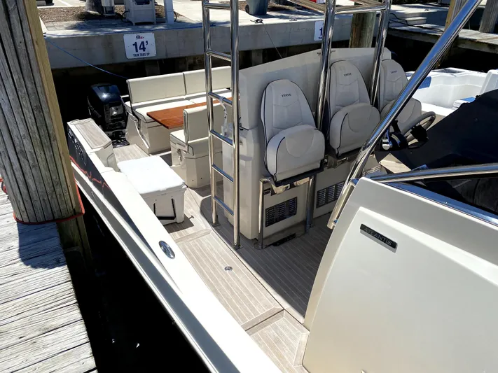  Yacht Photos Pics 2014 Azimut Atlantis Verve Outboard boat interior with seating and ladder at dock.