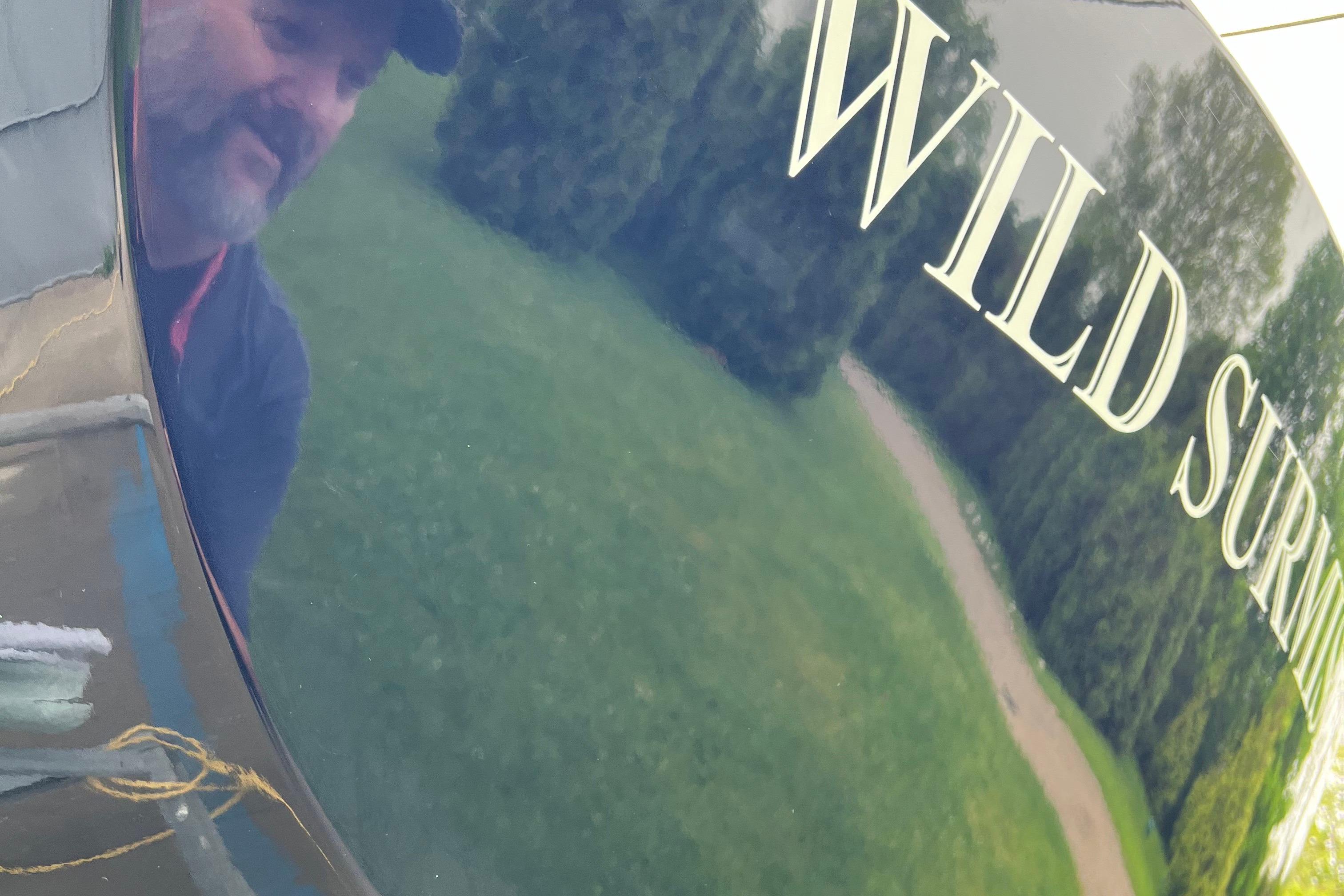 Reflection on 2013 Saffier Se 23ft boat with "Wild Surmi" text.