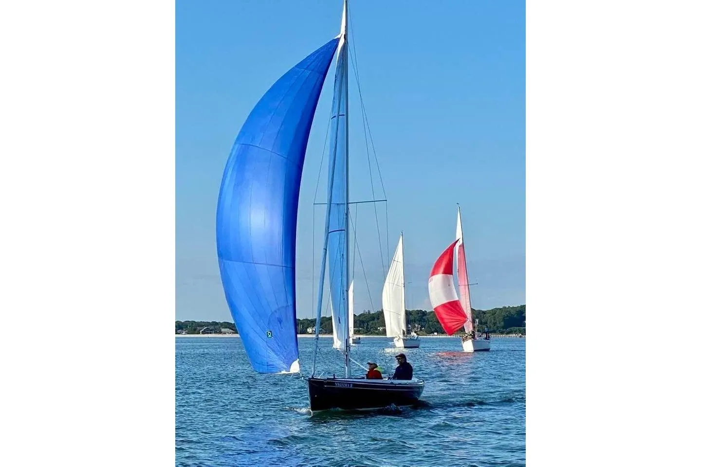 Saffier Se 23ft sailboat with blue spinnaker, 2013 model, sailing on a sunny day.