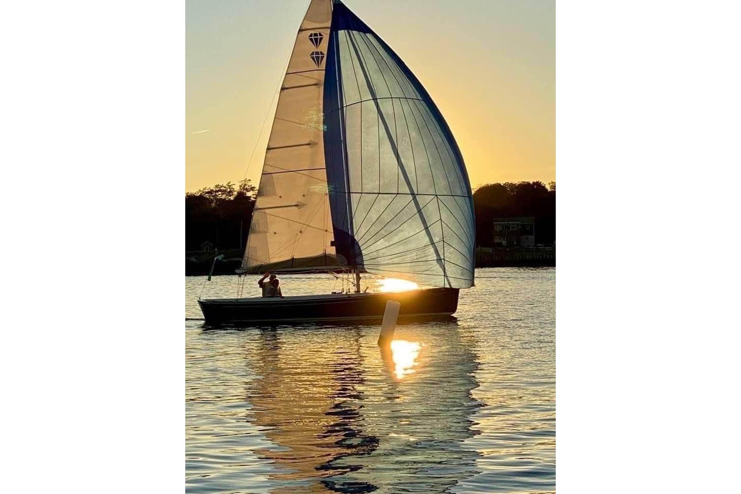 Saffier Se 23ft sailboat on water at sunset, 2013 model.