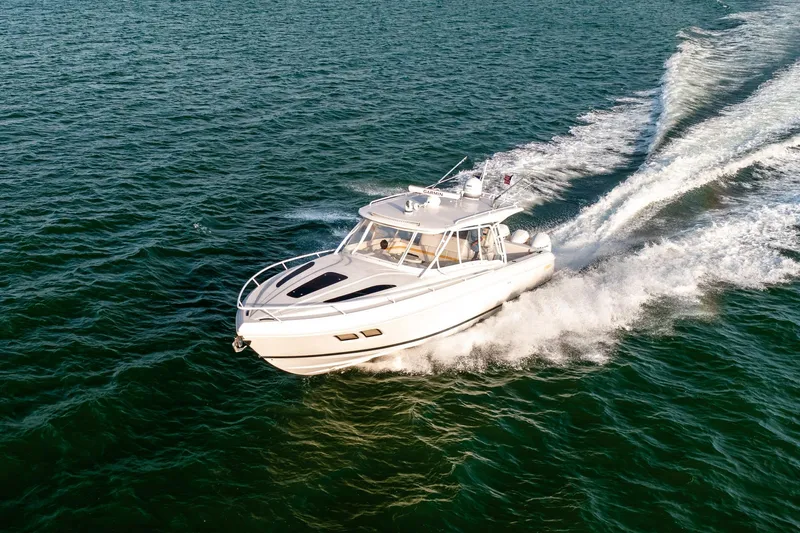  Yacht Photos Pics 2020 Intrepid 407 Cuddy cruising on open water, creating a dynamic wake.