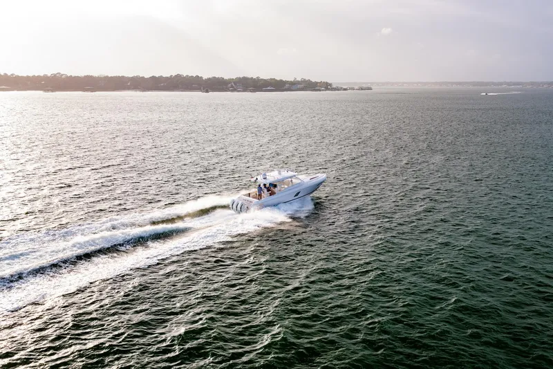  Yacht Photos Pics 2020 Intrepid 407 Cuddy cruising on open water at sunset.