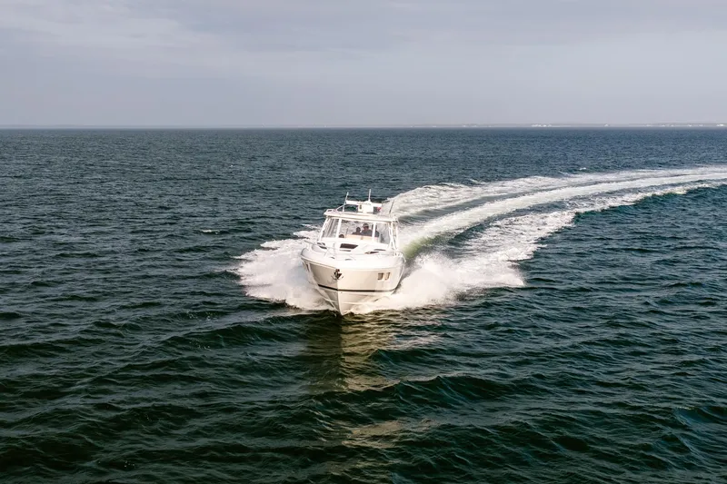  Yacht Photos Pics 2020 Intrepid 407 Cuddy cruising swiftly on open water.