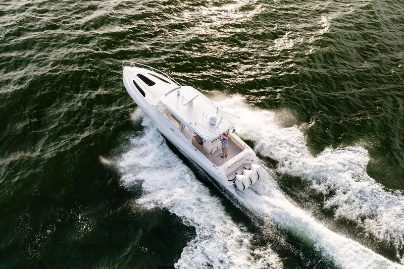  Yacht Photos Pics Aerial view of 2020 Intrepid 407 Cuddy boat cruising on open water.