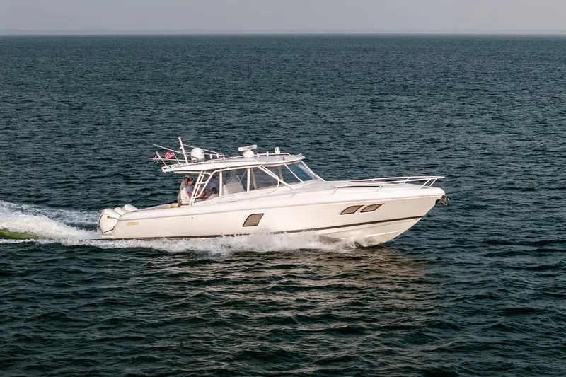  Yacht Photos Pics 2020 Intrepid 407 Cuddy cruising on open water, side view.