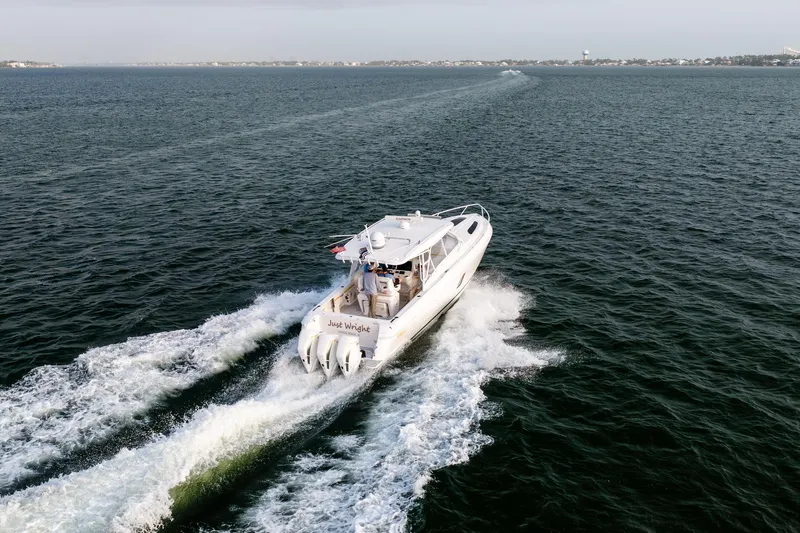  Yacht Photos Pics 2020 Intrepid 407 Cuddy cruising on open water, creating a wake behind.