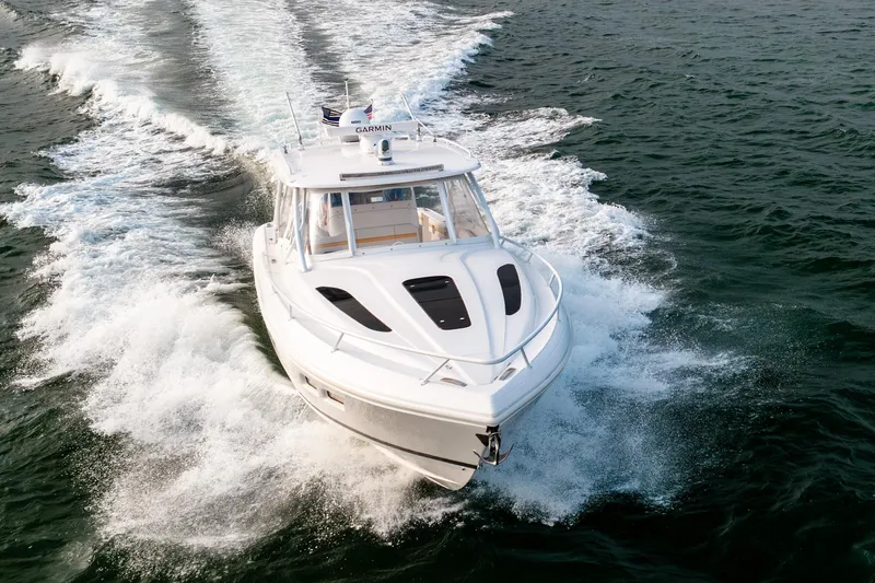  Yacht Photos Pics 2020 Intrepid 407 Cuddy cruising on open water, showcasing sleek design and performance.