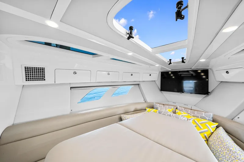  Yacht Photos Pics 2020 Intrepid 407 Cuddy interior with skylights, modern seating, and vibrant cushions.