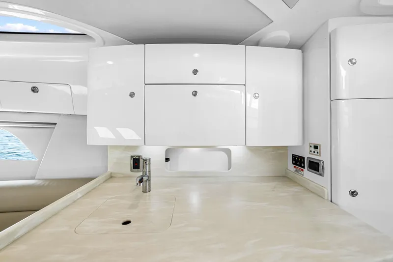  Yacht Photos Pics Modern kitchen area in 2020 Intrepid 407 Cuddy boat with sleek white cabinetry.